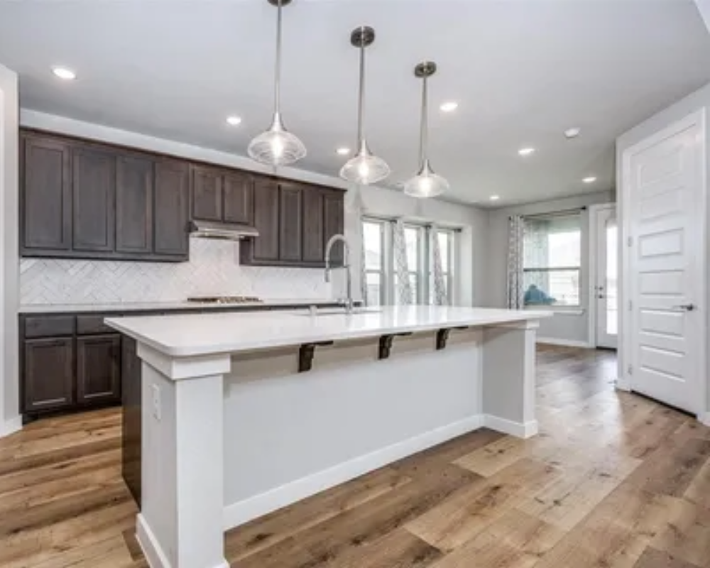 dark stained kitchen cabinets with white painted island, walls, trim and doors by Bear Creek Painting, Inc.